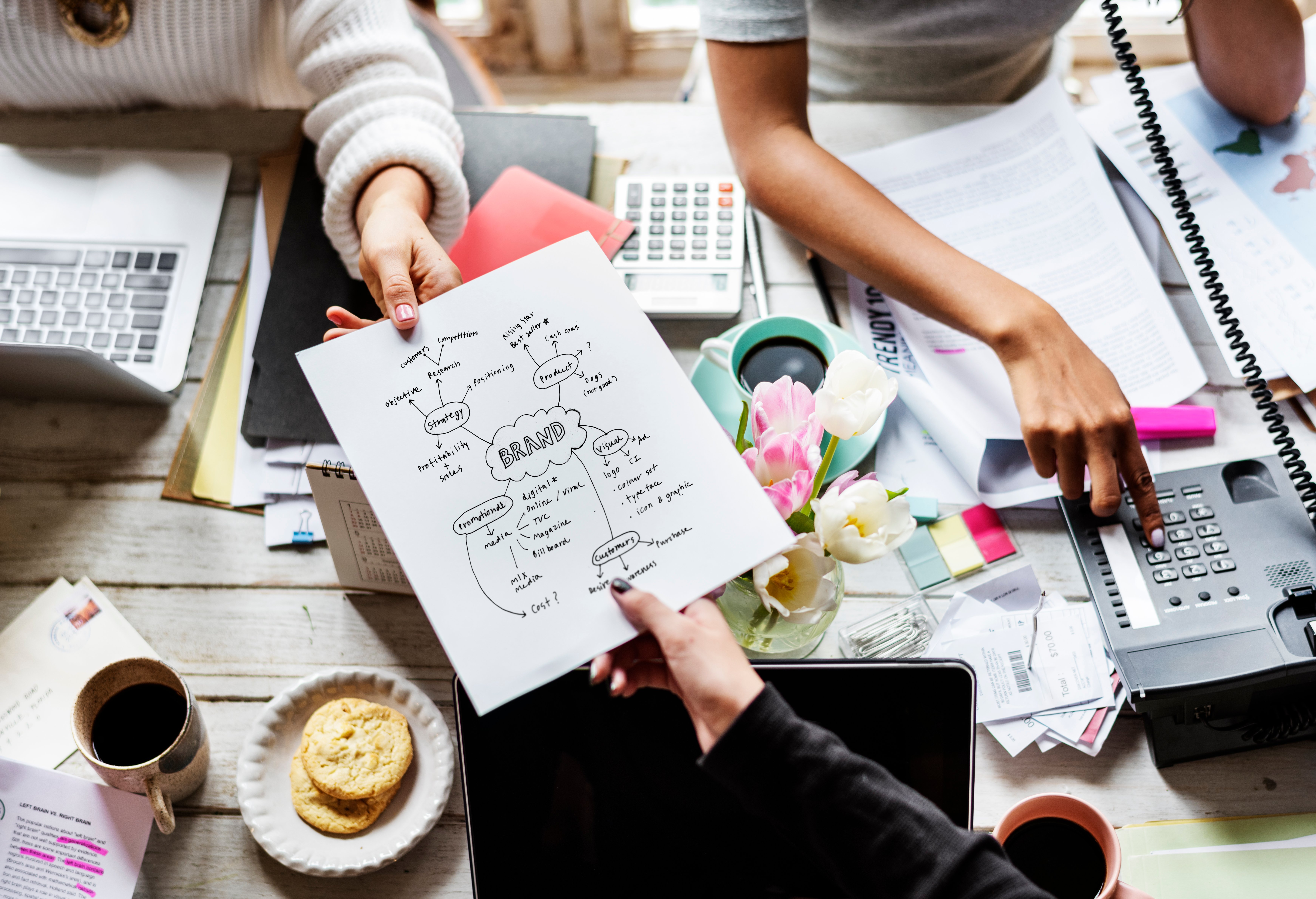 colleagues-handing-branding-plan-strategy-to-other-2021-08-27-00-01-44-utc